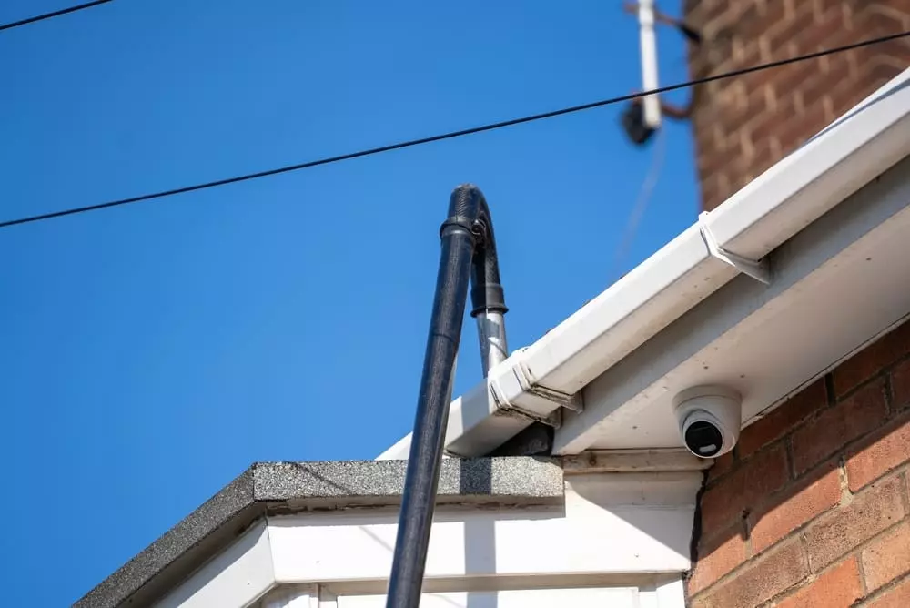 telescoping vacuum cleaning out gutter