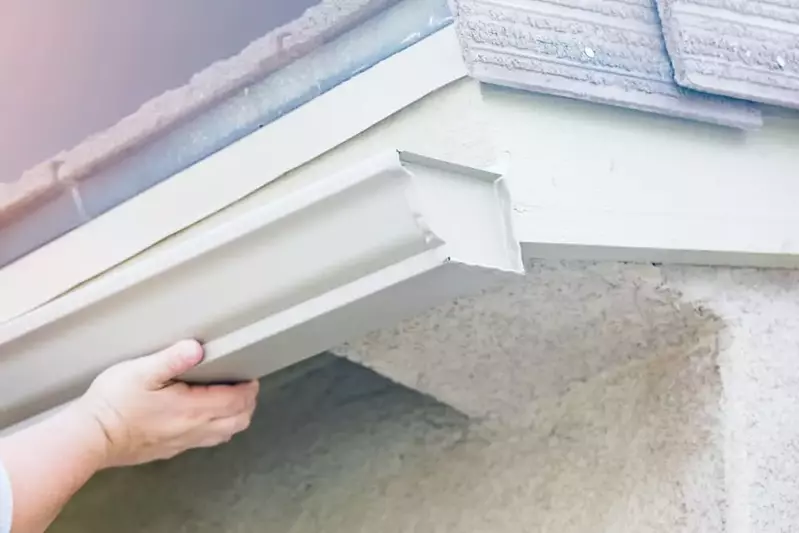 worker installing new gutters