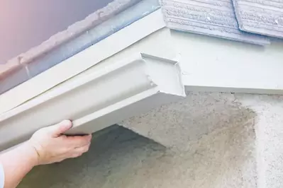 worker installing new gutters