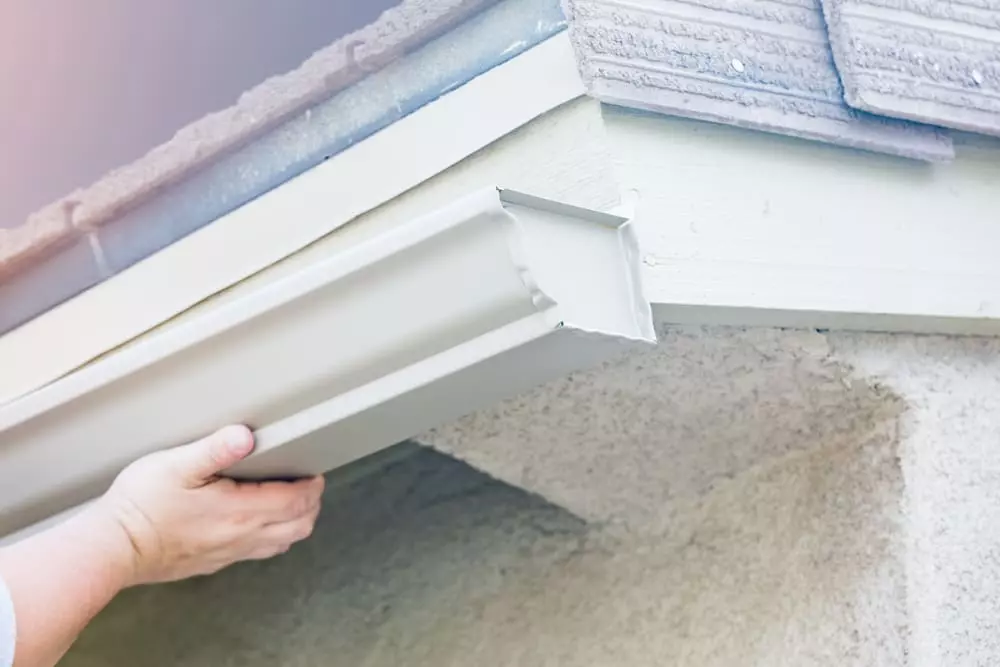 worker installing new gutters