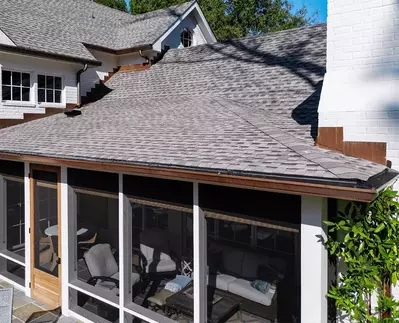 Half-round copper gutter system from GutterPro installed on a classic white brick home to add a touch of luxury and sophistication