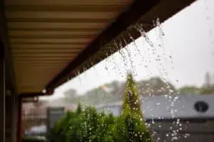 water flowing over side of gutter