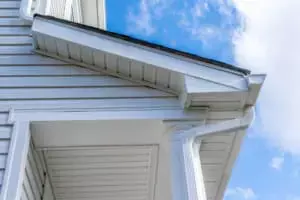 white gutter system connecting to downspout