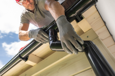 man working on black gutter