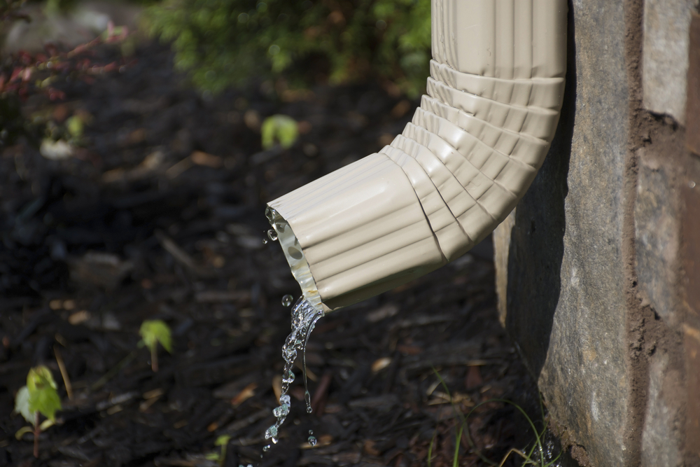 water flowing from gutter downspout