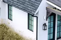 new black gutter system on white brick house