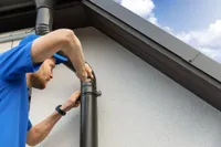 attaching gutter downspout to home