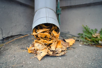 a blocked downspout can cause gutters overflowing